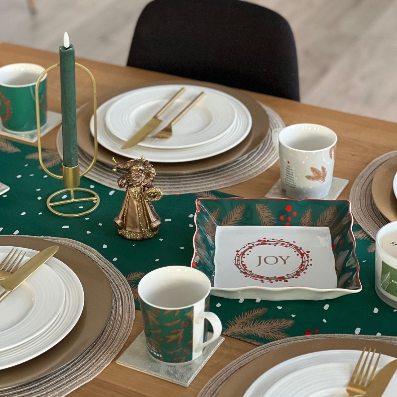 Christmas Festive Fir Table Runner by Mindy Brownes Interiors Introducing our Festive Fir collection. This charming collection is adorned with beautiful designs inspired by Christmas fir branches, red berries, and heartwarming holiday messages on green and white backgrounds.
