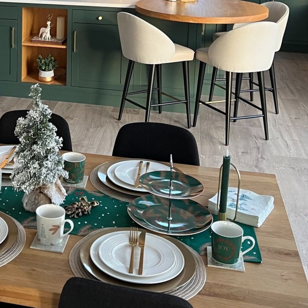 Christmas Festive Fir Two Tier Cake Stand by Mindy Brownes Interiors Introducing our Festive Fir collection. This charming collection is adorned with beautiful designs inspired by Christmas fir branches, red berries, and heart-warming holiday messages on green and white backgrounds.