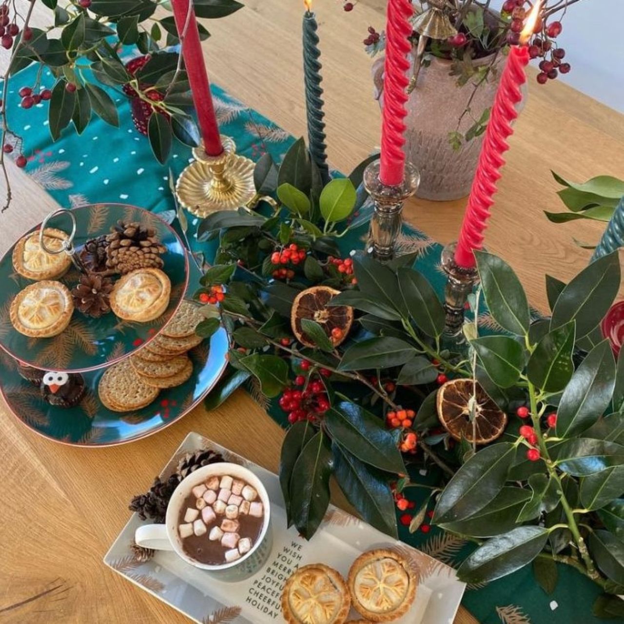 Christmas Festive Fir Two Tier Cake Stand by Mindy Brownes Interiors Introducing our Festive Fir collection. This charming collection is adorned with beautiful designs inspired by Christmas fir branches, red berries, and heart-warming holiday messages on green and white backgrounds.