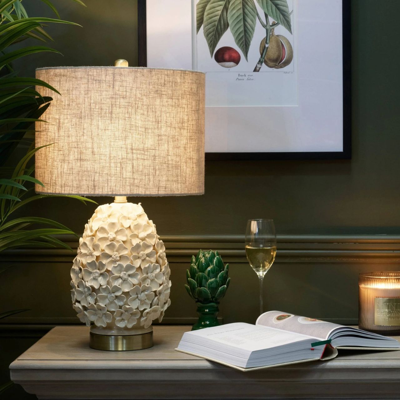 The Sara Lamp offers a soft and elegant take on floral inspired design. Its rounded ceramic base features delicate raised blossoms in a gentle neutral finish, creating texture and a subtle romantic feel. Paired with a linen shade, it casts a warm, inviting glow that highlights the intricate detailing.
