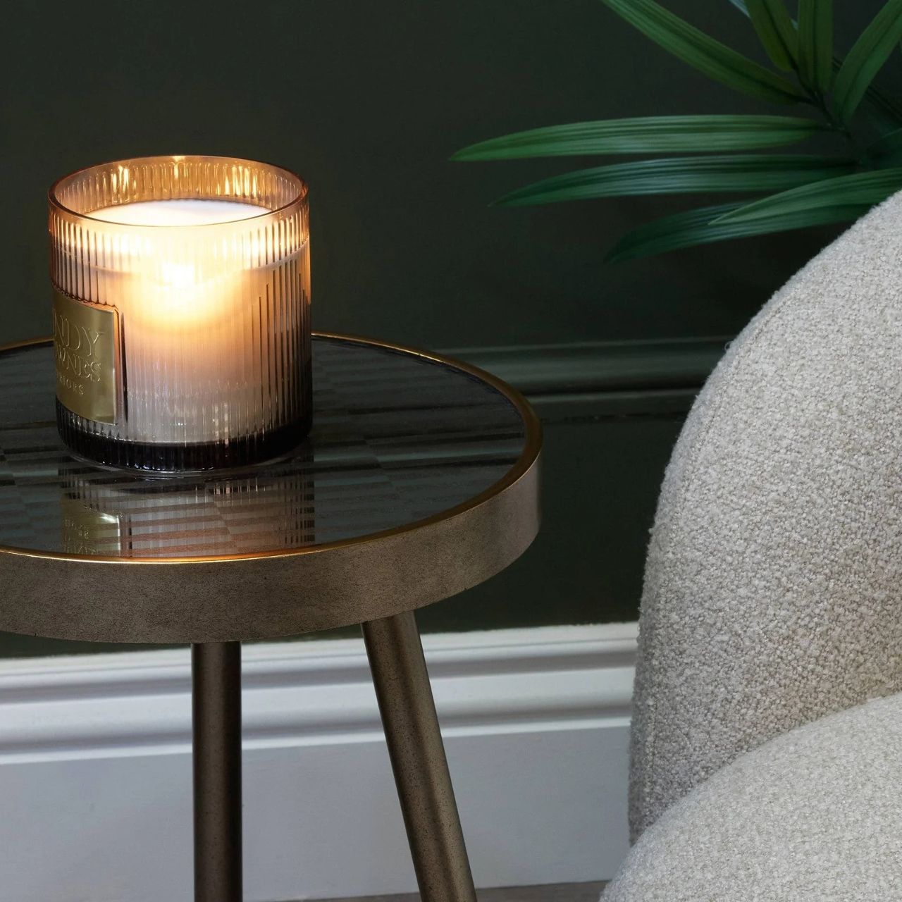 This beautiful tripod table features a mirrored top with a flowing wave design and a sleek distressed finish. Its elegant three legged base creates a light, balanced look while reflecting light to enhance the space.