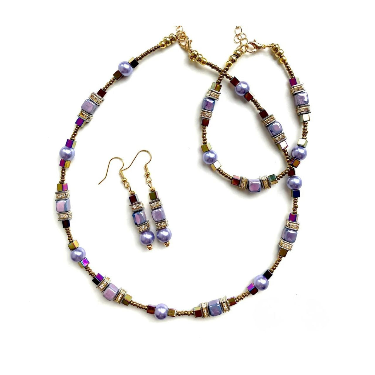 Combined cubes and spheres for a dynamic effect using lilac coloured Ceramic cubes and gold plated Hematite gemstones teamed with toning Pearls, all interspersed with sparkling Rhinestone spacer beads, creating an easy to wear and flattering piece of jewellery.