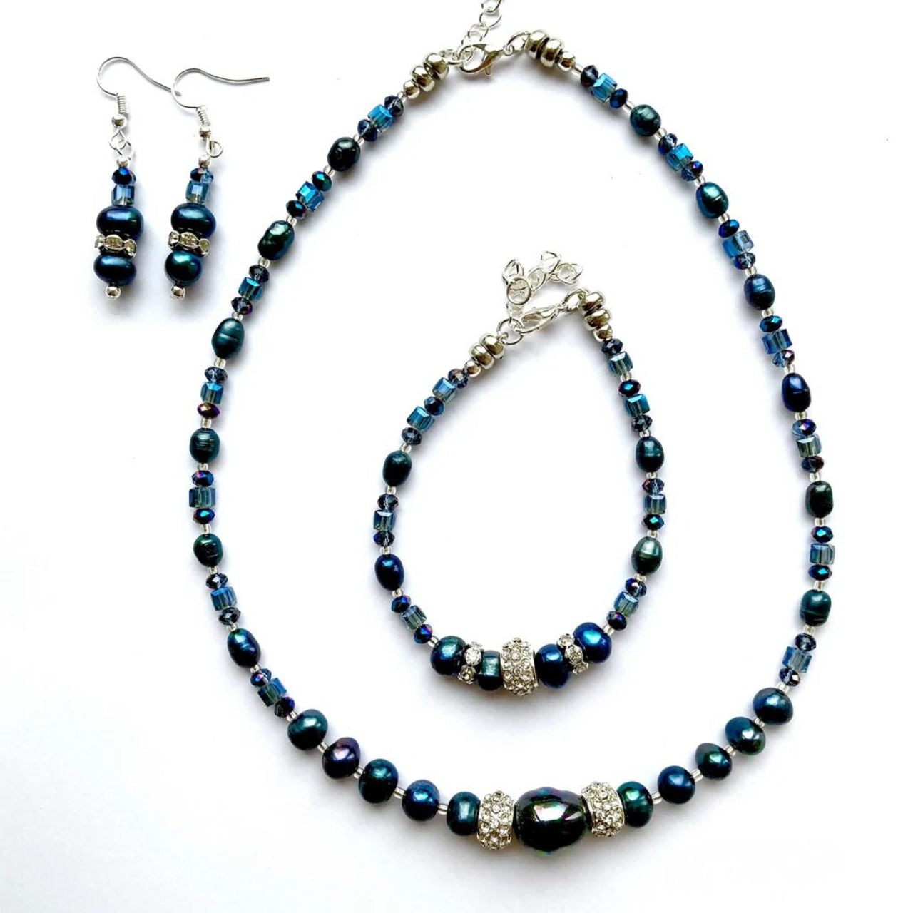 These freshwater Pearls have an unsurpassed natural beauty. Their deep blue colour is complemented by little faceted blue Crystal rondelles and cubes and highlighted by elegant cubic zirconia-studded silver collars.