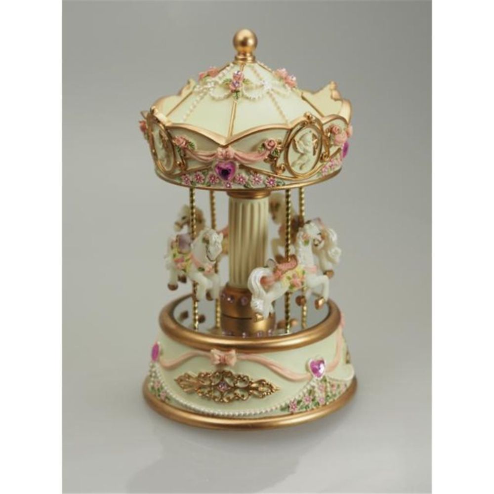Music box carousel beige. The pretty cream coloured carousel is decorated with pink glass stones and bows. The base is decorated with golden ornaments. 4 richly adorned carousel horses are ready to go. When turning the roof, the mechanism is wound up an the carousel on the base turns to the melody “Minuet Mozart” plays.
