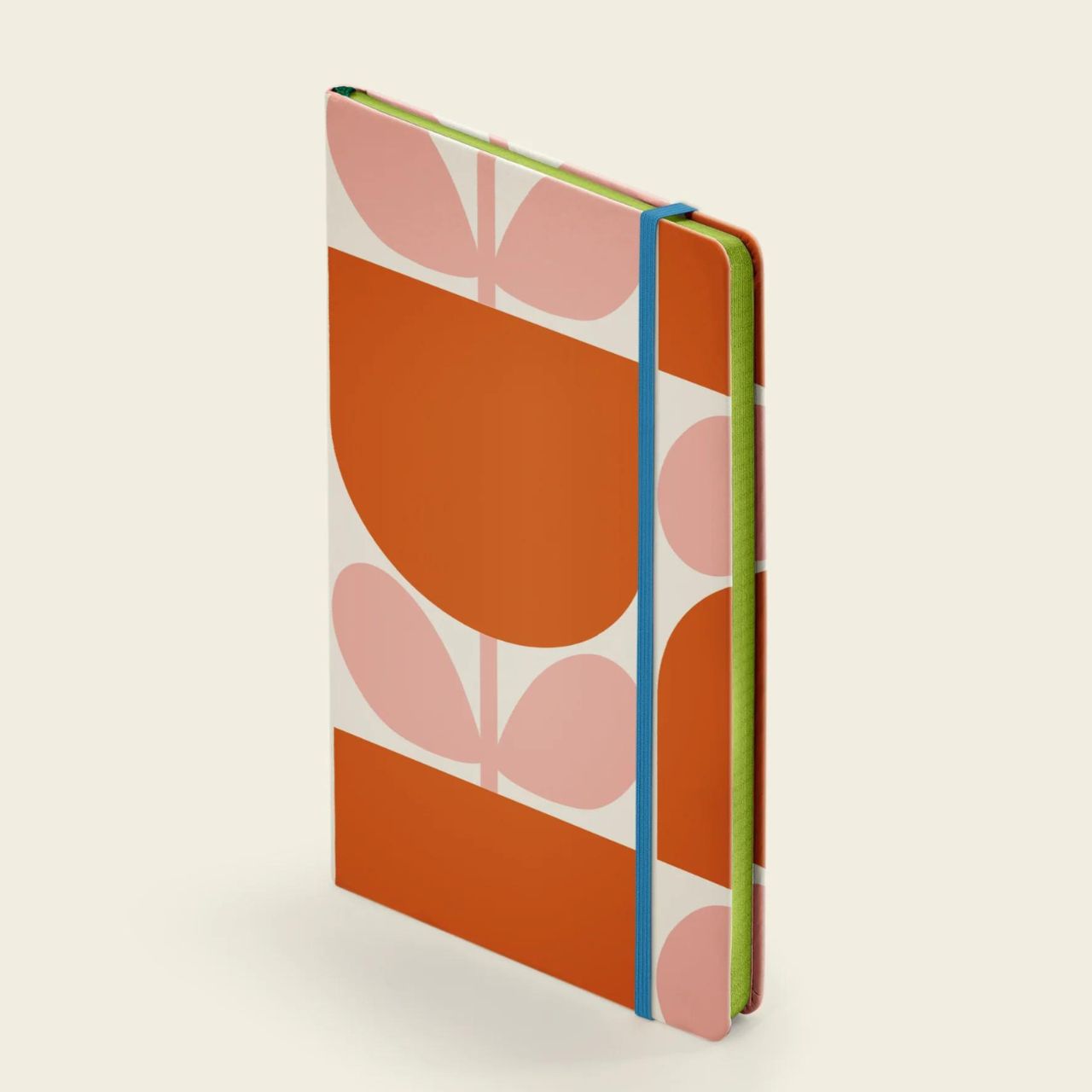 Orla Kiely Medium Notebook - Block Flower  Organize your goals, plans, and weekly shopping list in a sleek and stylish manner with our Block Flower notebook. Featuring a sturdy hardcover, rounded corners, elastic closure, and matching ribbon bookmark, this notebook also includes a grid square paper layout and an expandable inner back pocket.
