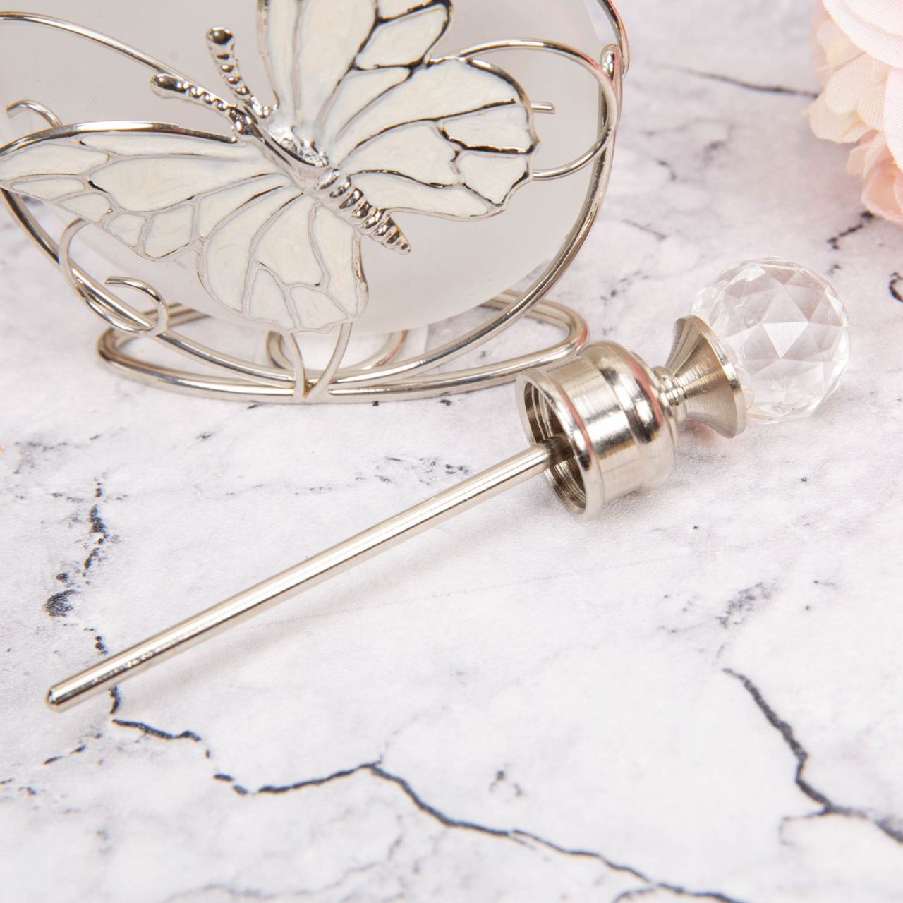 Perfume Bottle Glass & Wire with Butterfly An elegant frosted glass perfume bottle with an intricate handmade wire butterfly design and cut crystal stopper. From SOPHIA - the home of style & sophistication in women's giftware.