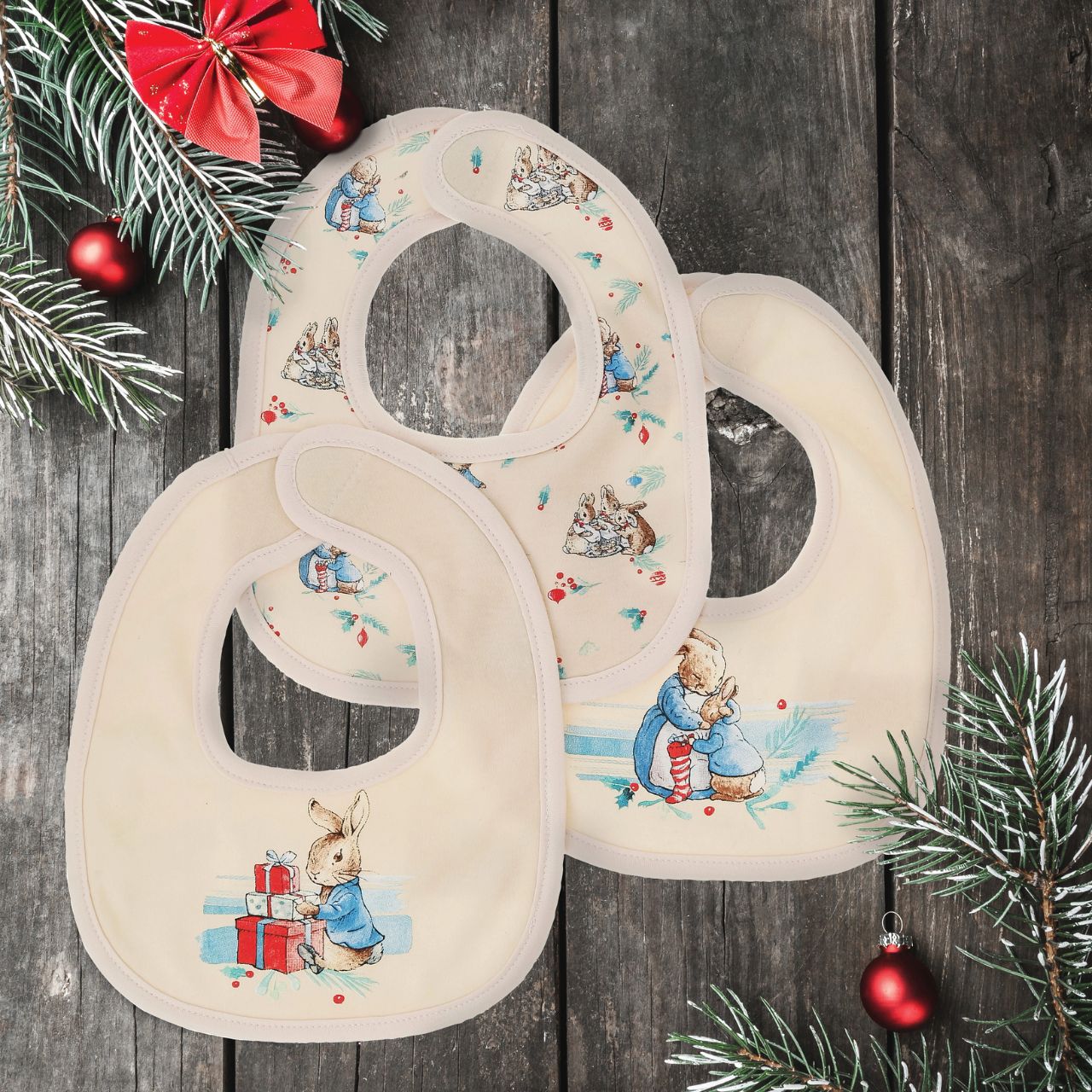 The Peter Rabbit Christmas Bibs set combines gorgeous festive designs with a practical and durable protective product. Featuring three designs, each based on the original Beatrix Potter illustrations, super soft fabric and easy-peasy fastenings, we've got mealtimes, and baby, covered.