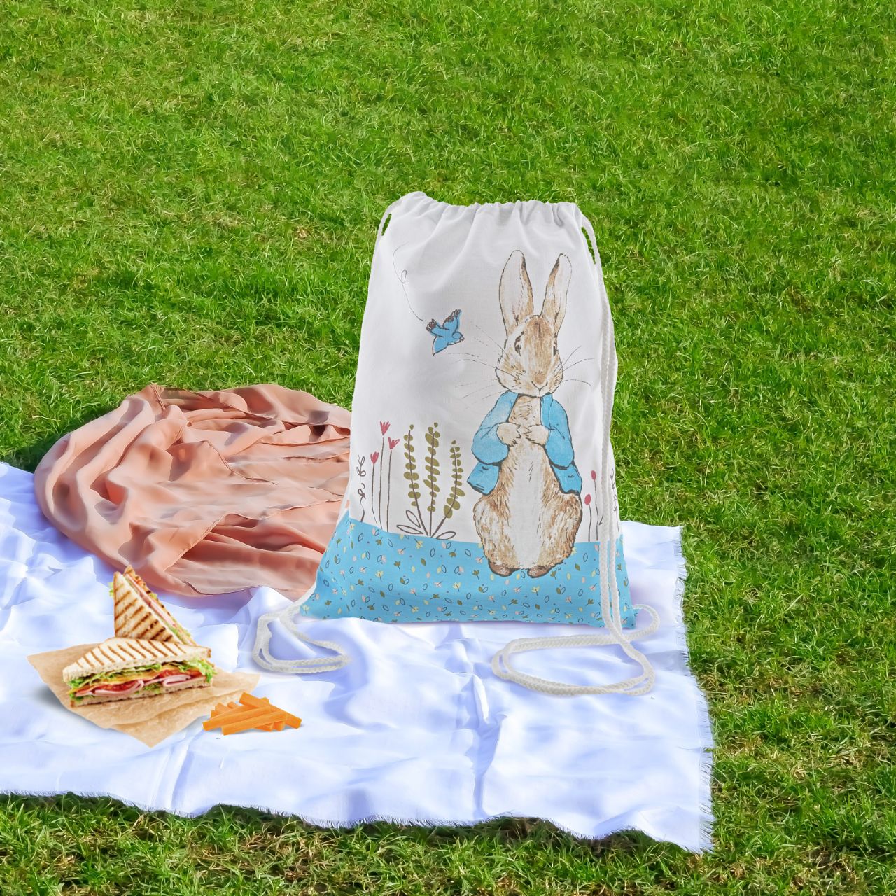A beautiful Peter Rabbit cotton drawstring bag. This is a lovely little bag that would make a perfect nursery, or pre-school bag for your child to pop all their school essentials in. It is also a great alternative to a storage bag to place all your little one's toys in, and of course an easy way to take their much loved Peter Rabbit teddies everywhere they go.