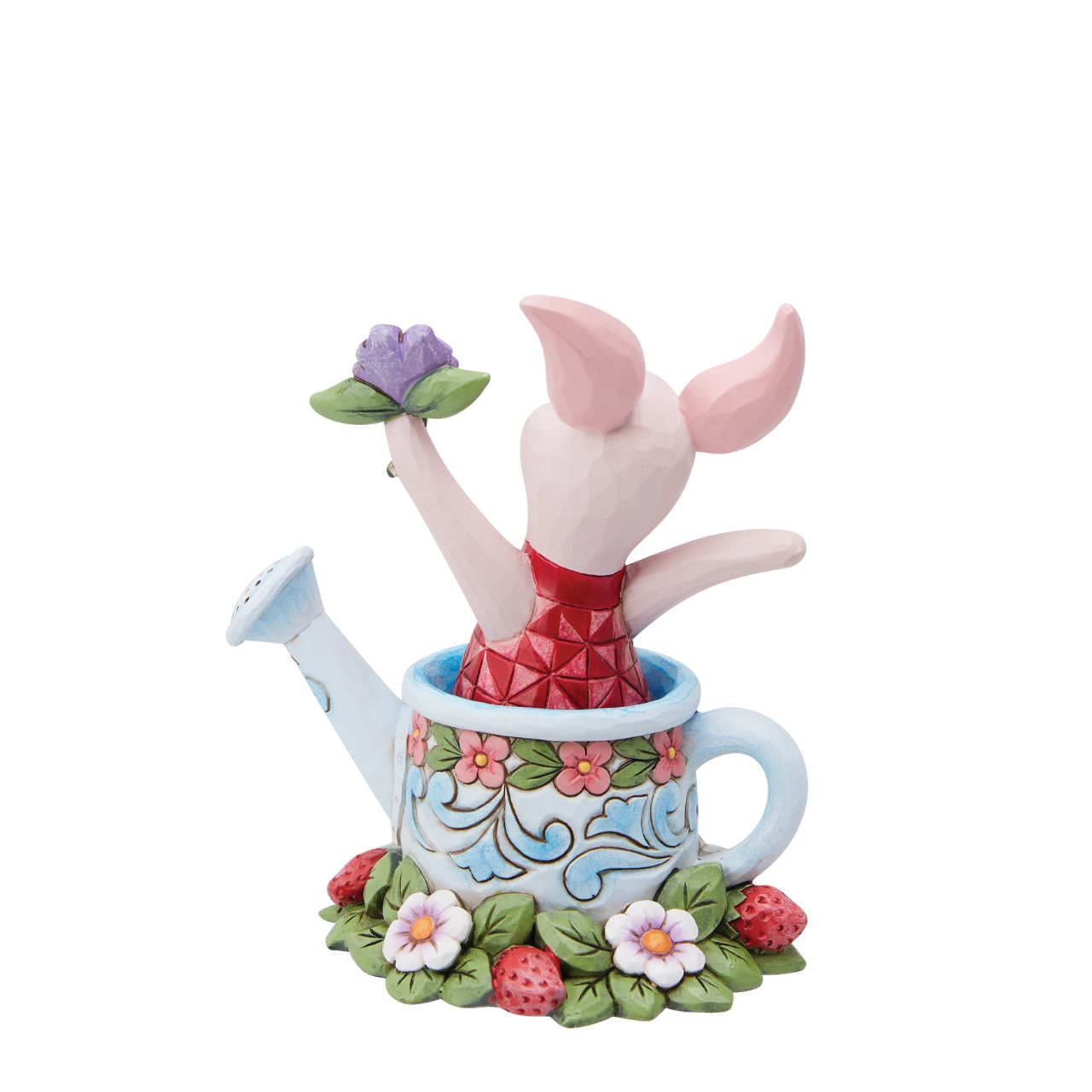Piglet in a Watering Can Figurine Introducing the delightful Piglet in a Watering Can Figurine from Disney Traditions by Jim Shore. Dressed in his signature pink jumper, this lovable character is holding a beautiful, pastel purple flower in his hand. This charming figurine is whimsical and heart-warming, bringing joy and magic to any collection of Disney figurines.