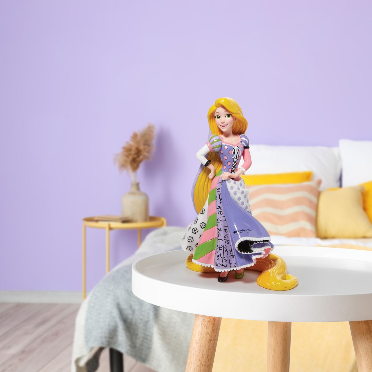 Rapunzel can be seen here with her iconic long magical hair in this unique pop art figurine. With bold colour and compelling pattern, contemporary artist Romero Britto captures the fun and whimsy of Disney.
