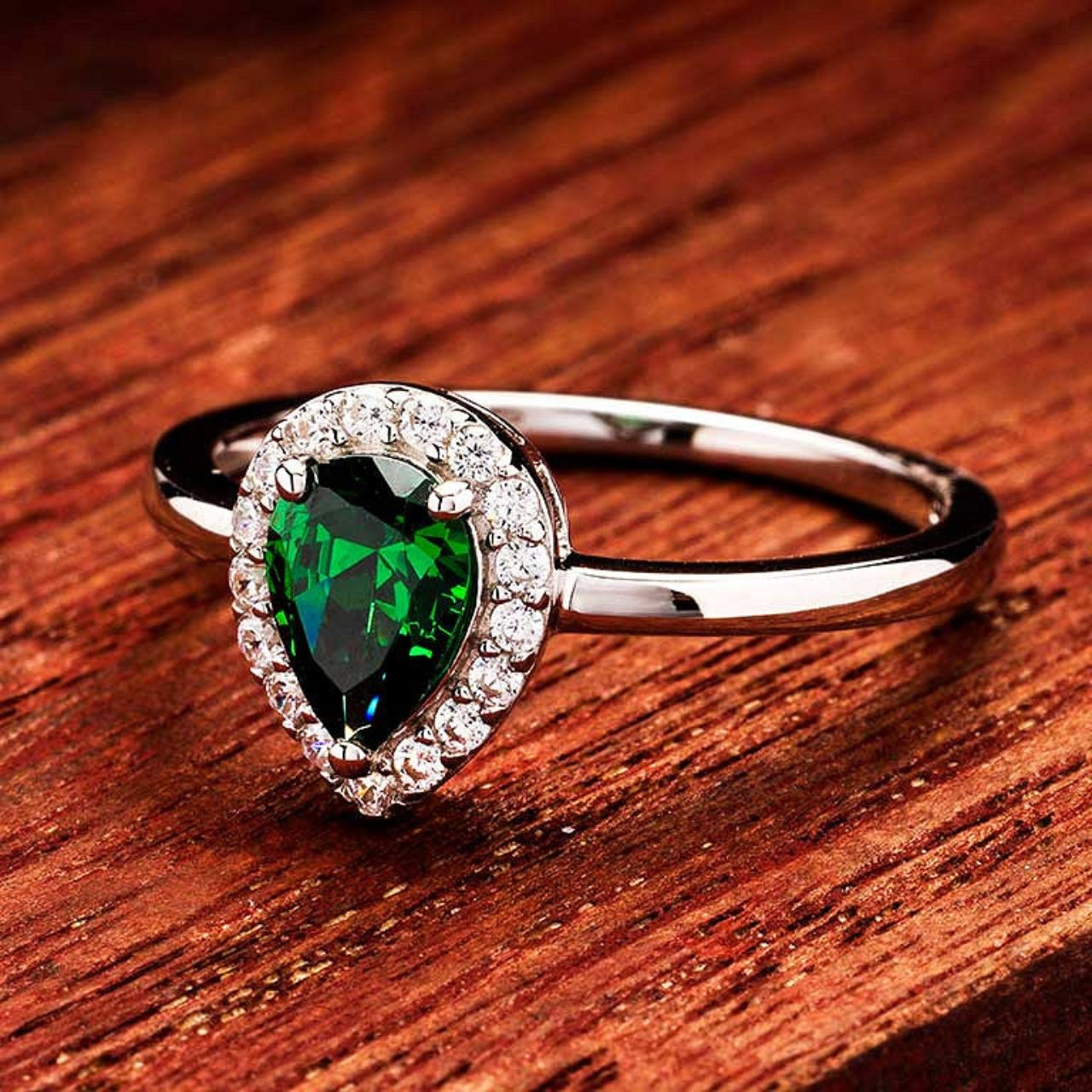 Elevate your elegance with the ShanOre Sterling Silver Emerald CZ Halo Ring. Featuring a radiant emerald-cut cubic zirconia center surrounded by a delicate halo of shimmering stones, this ring offers refined sophistication and timeless style.