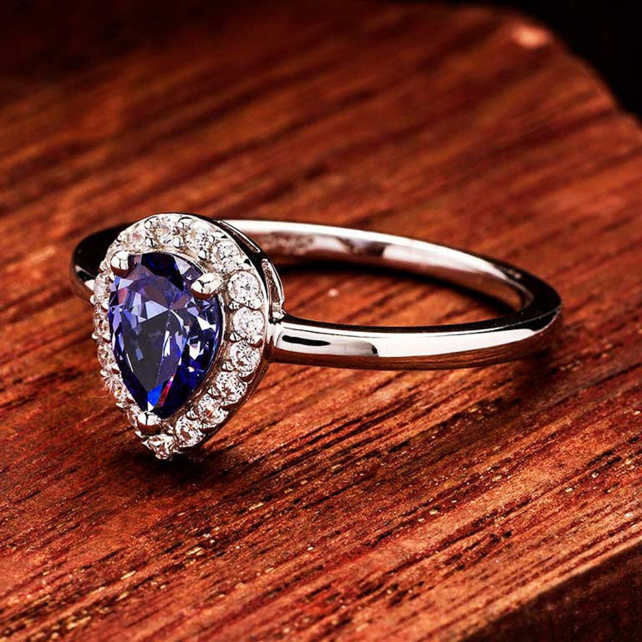 Elevate your elegance with the ShanOre Sterling Silver Tanzanite CZ Halo Ring. Featuring a stunning tanzanite-inspired center stone surrounded by sparkling cubic zirconia, this ring offers timeless sophistication and brilliant shine.