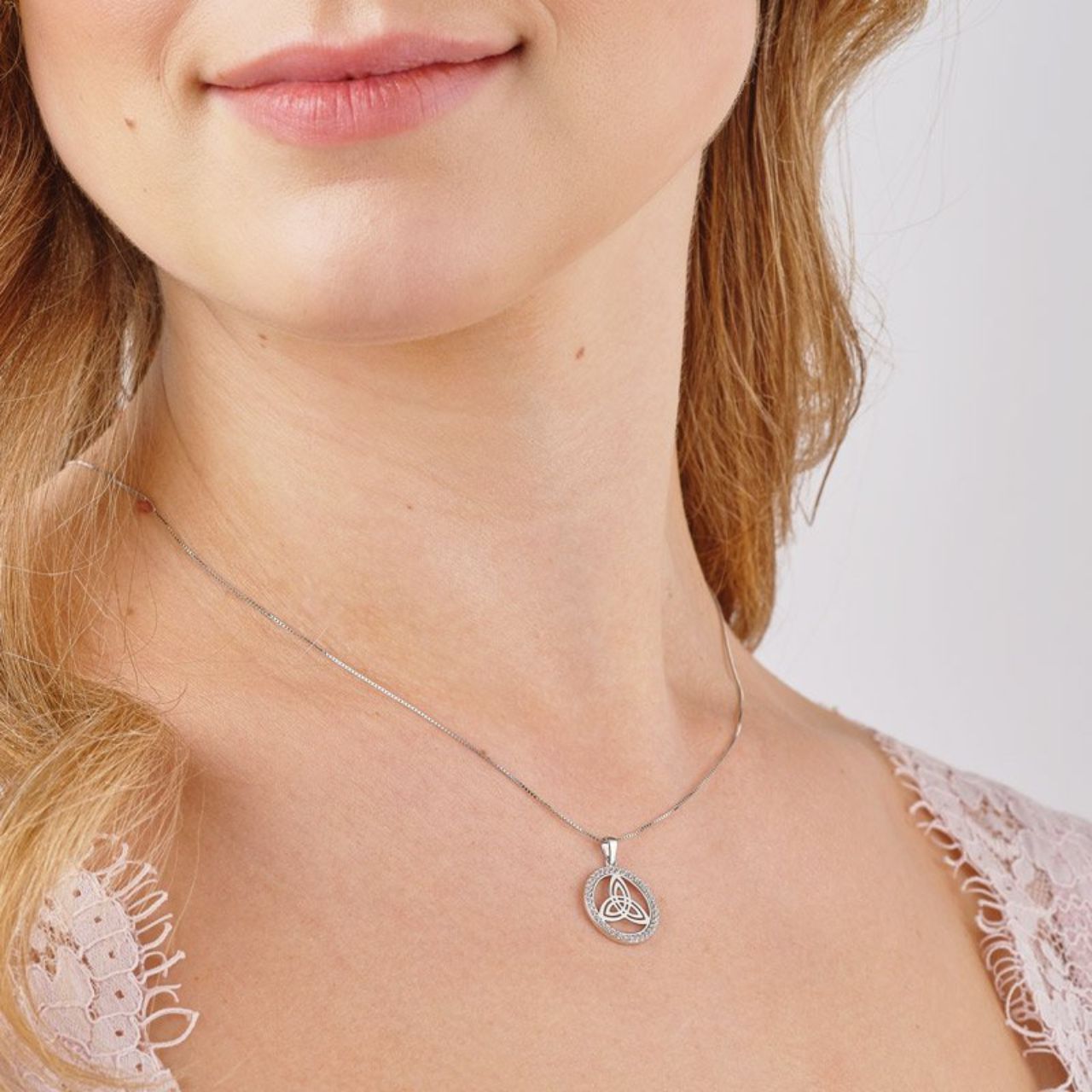 Sterling Silver CZ Round Trinity Knot Necklace This sterling silver Trinity necklace represents eternal life and ever lasting love. It is designed in a disc shape with a surround of cubic zirconia, giving it an added touch of sparkle.