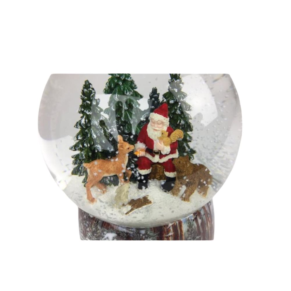 Snow globe Santa in the forest. Santa sits in the globe filled with snow between a few wild animals and feeds them between the snowy fir trees. The base is painted with snowy forest scenes.
