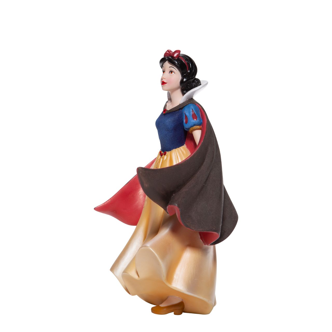 Snow White Couture de Force Figurine Snow White with her skin fair as snow and lips red as apples follows the wind on a new adventure fit for a princess. Hand-crafted and hand-painted, her iconic outfit shimmers in yellow satins and dark wool felts plussed with red faux gem stones.