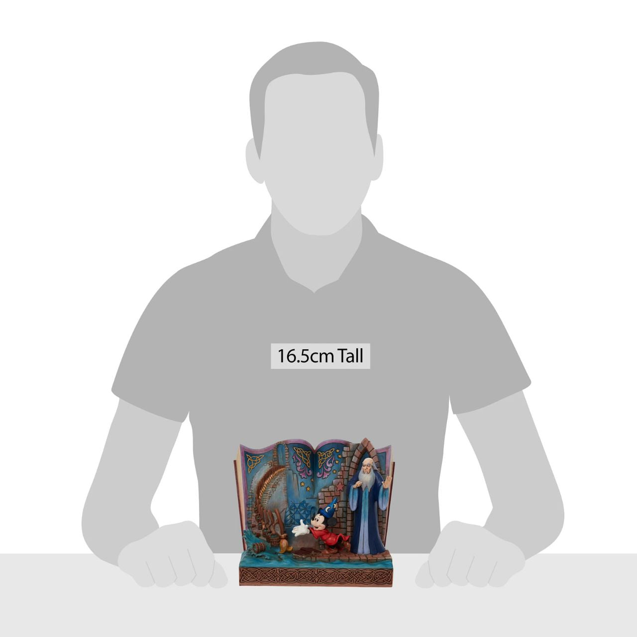 Disney Showcase Sorcerer Mickey Storybook Figurine Jim Shore re-imagines Fantasia in fantastic fashion in this enchanting statuette by Jim Shore. Mickey Mouse plays sorcerer as he enchants broomsticks to do chores while mentor Yen Sid watches. The complete scene rests inside the pages of a storybook.