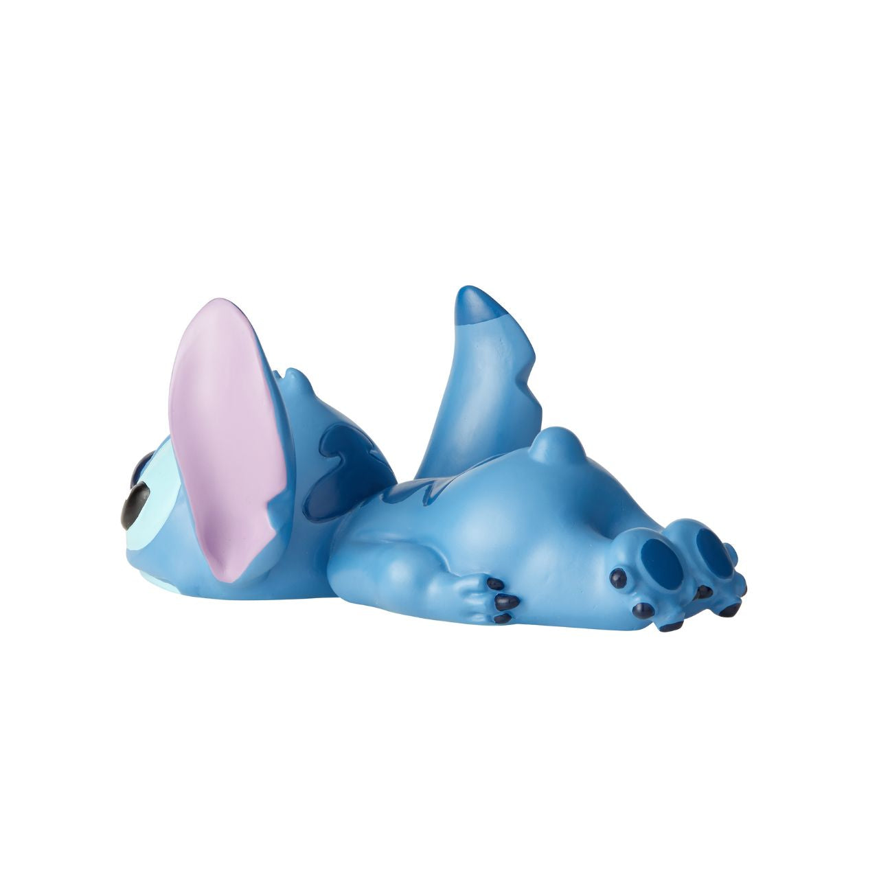 Stitch Laying Down Figurine by Disney Showcase Stubborn Stitch is still as cute as ever, and this little guy can't help but make you smile. Cute, clever and charismatic, Stitch's fun-loving nature is just what you need to brighten your day.