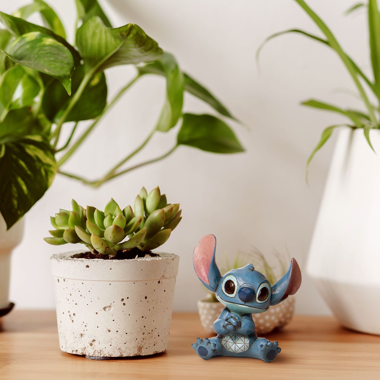 Jim Shore Stitch Mini Figurine Everyone's favourite alien, Stitch, looks extra adorable in this mini figurine by Jim Shore. Hands clasped, the temperamental alien appears soothed in this figurine, one can only imagine he's listening to Elvis records or watching Lilo hula.