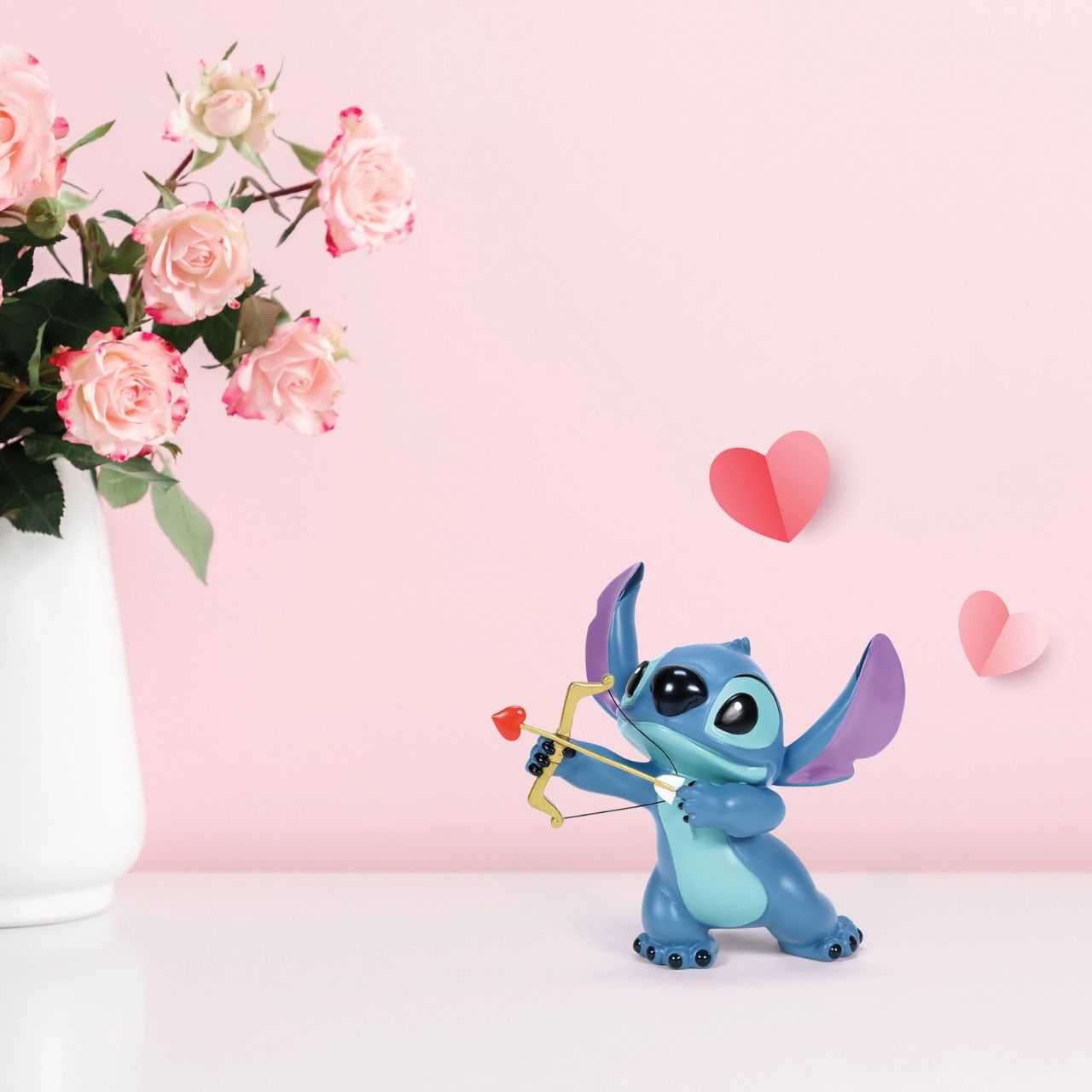 Meet our Stitch Valentine's Moment Figurine, the perfect blend of love and mischief. Handcrafted in vibrant detail, this piece features Stitch charmingly dressed as Cupid, wings and all. Sure to draw hearts and smiles, this romantic, whimsical piece is ideal for Disney fans or anyone yearning for a splash of enchantment.