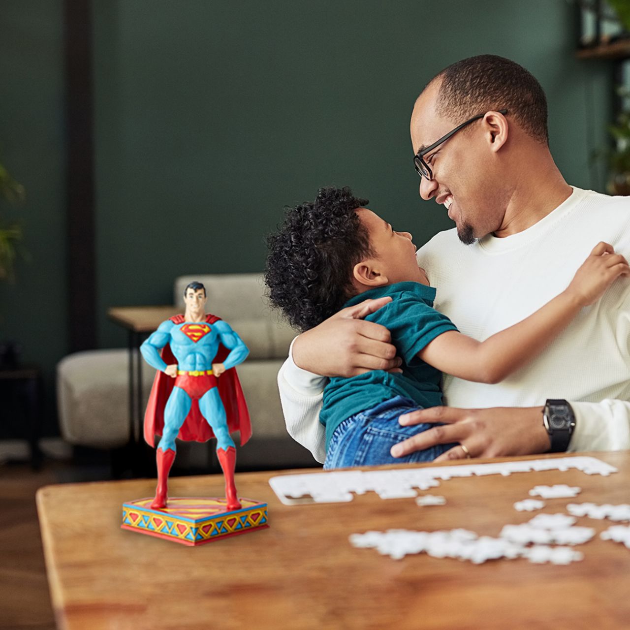 Jim Shore Man of Steel Superman Silver Age Figurine DC Comics Justice League is a comprised of the worlds most iconic superheroes. Jim Shore celebrates Superman in an iconic pose in his signature wood carved look and folk art styling. Sure to be a treasured gift across the generations.