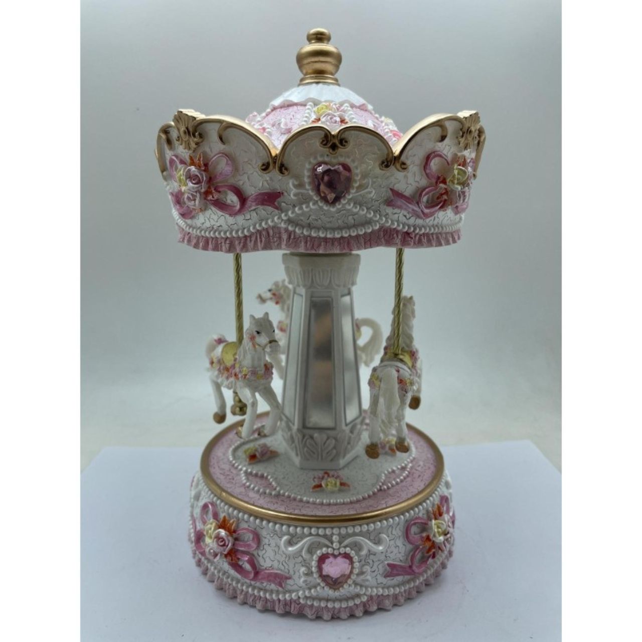White and rose coloured Carousel turns to a welknow melody.