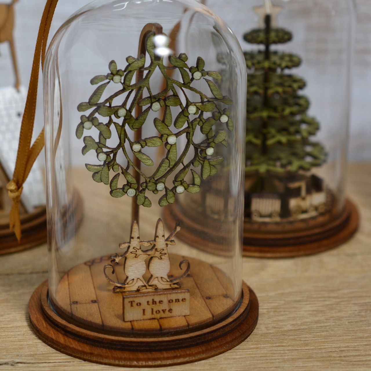 The One I Love at Christmas Hanging Ornament The Spirit of Christmas. A collection of delightful wooden decorations that capture the essence of that special time of year. This glass dome, Christmas decoration encases two happy little mice, adorned under a large amount of Christmas Mistletoe and finished with ribbon to help hang off your Christmas tree.