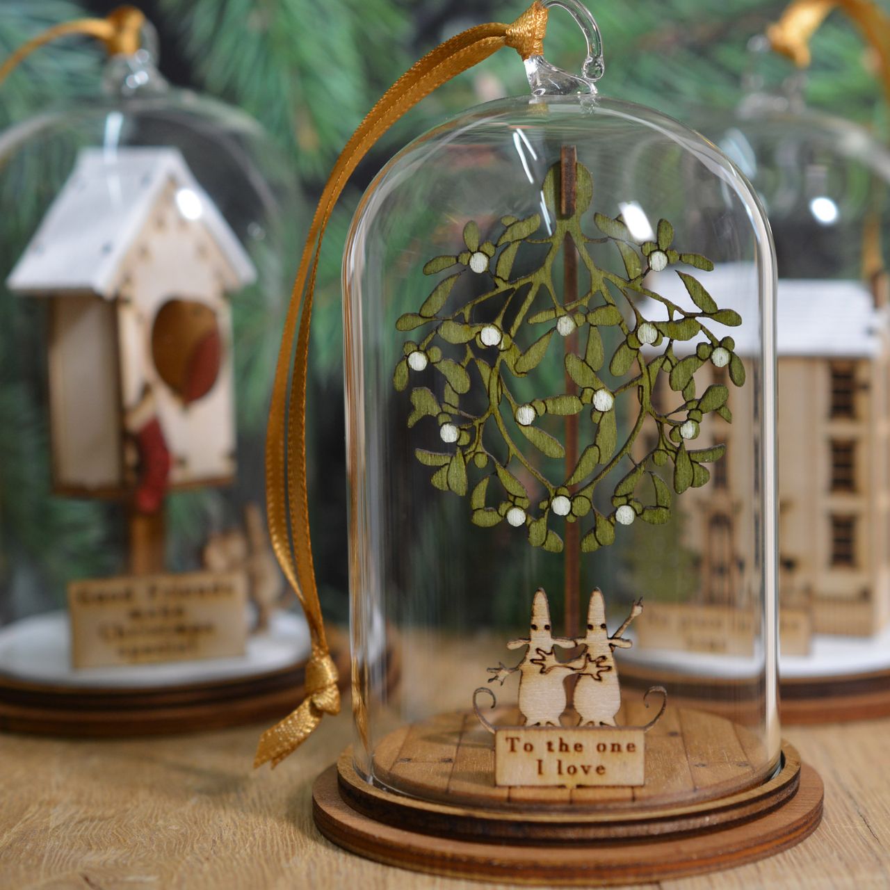 The One I Love at Christmas Hanging Ornament The Spirit of Christmas. A collection of delightful wooden decorations that capture the essence of that special time of year. This glass dome, Christmas decoration encases two happy little mice, adorned under a large amount of Christmas Mistletoe and finished with ribbon to help hang off your Christmas tree.