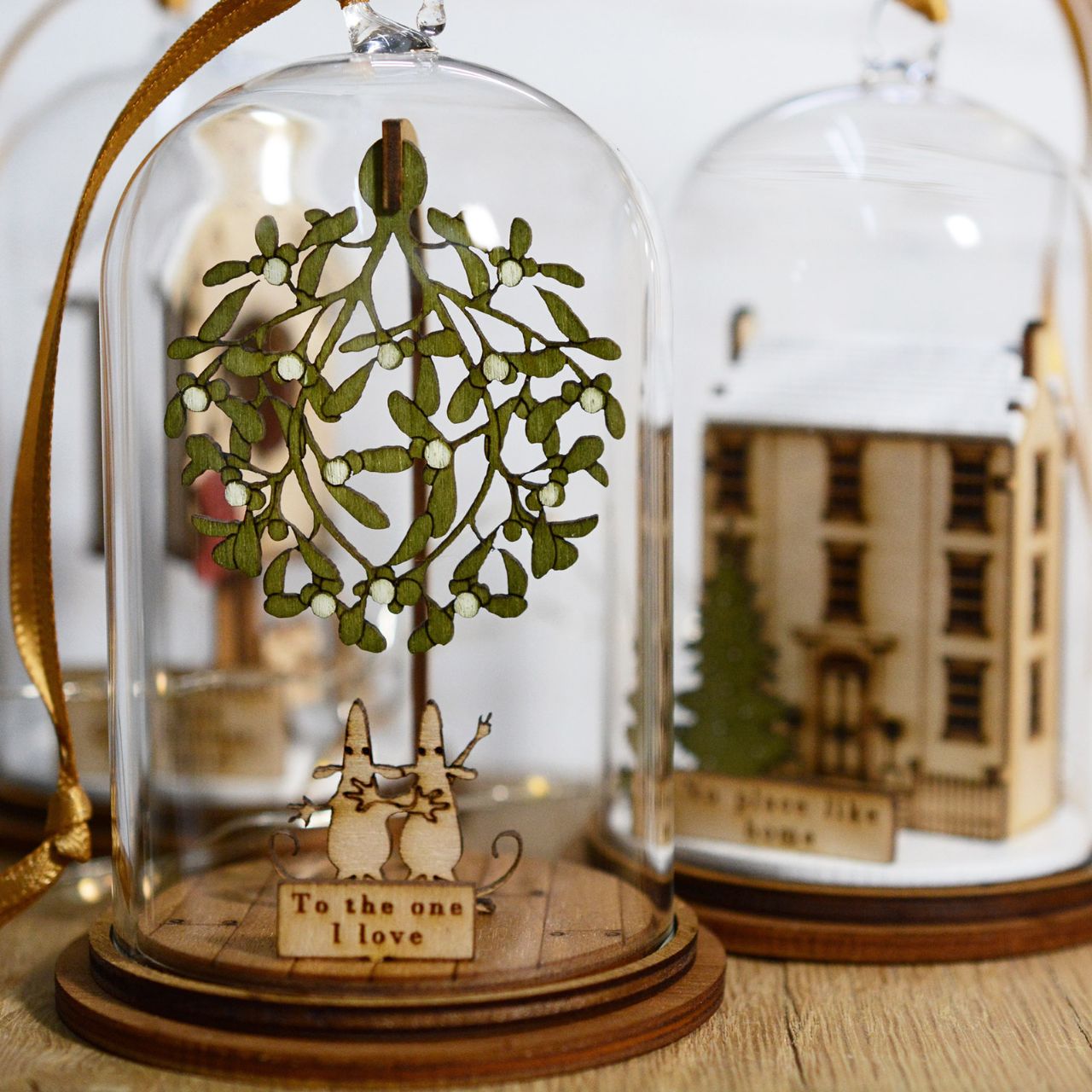 The One I Love at Christmas Hanging Ornament The Spirit of Christmas. A collection of delightful wooden decorations that capture the essence of that special time of year. This glass dome, Christmas decoration encases two happy little mice, adorned under a large amount of Christmas Mistletoe and finished with ribbon to help hang off your Christmas tree.
