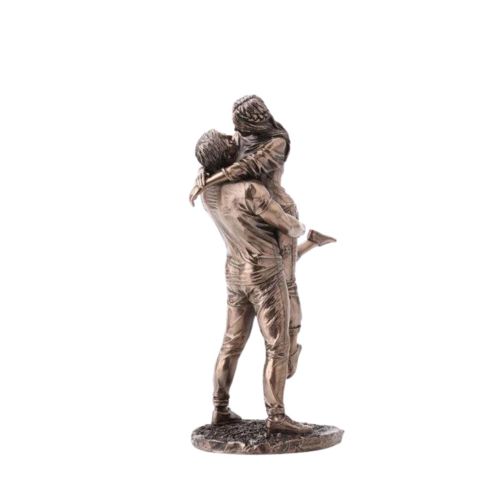 The Promise by Genesis Ireland A beautiful bronze coloured statue of a couple in a loving embrace. Perfect for art lovers or for an occasional gift such as a engagement or anniversary gift.