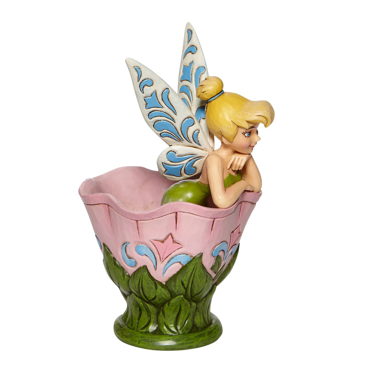 Disney Tinkerbell Sitting in a Flower Figurine A Spot of Tink by Jim Shore All the way from Neverland, this sweet and sassy fairy, takes a flower break before she's off on her next adventure. This Disney by Jim Shore piece is intricately hand sculpted and is great for any Tinker Bell enthusiast. Made from cast stone.