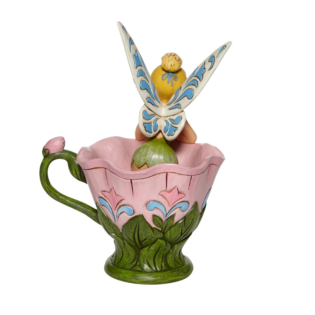 Disney Tinkerbell Sitting in a Flower Figurine A Spot of Tink by Jim Shore All the way from Neverland, this sweet and sassy fairy, takes a flower break before she's off on her next adventure. This Disney by Jim Shore piece is intricately hand sculpted and is great for any Tinker Bell enthusiast. Made from cast stone.