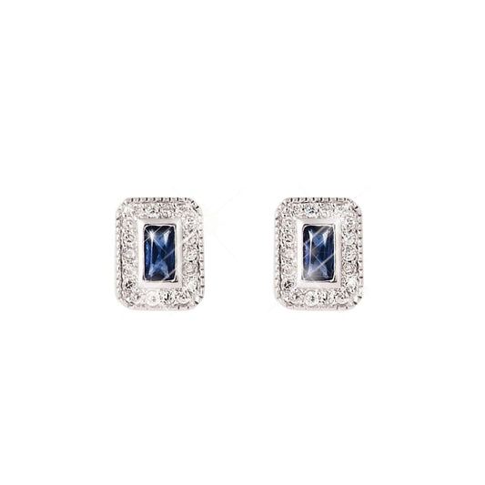 Elegance and pizzaz are presented in equal measure with these rich sapphire earrings. The halo frame of bright, round, clear crystals intensiﬁes the radiance of the blue emerald cut center stone. These delicate and timeless studs are sure to be a treasured favourite. Polished to a bright lustre they secure comfortably with push backs.