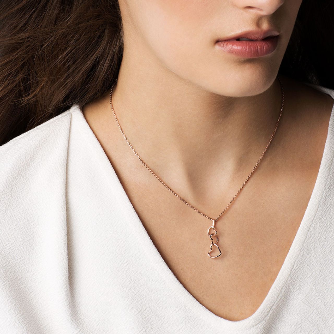 In soft, romantic rose gold this dainty heart pendant is the perfect way to say “I love you”. Three graduating open hearts are interlinked in a clever linear drop which suspends from a sleek bale which runs freely along a cable chain.