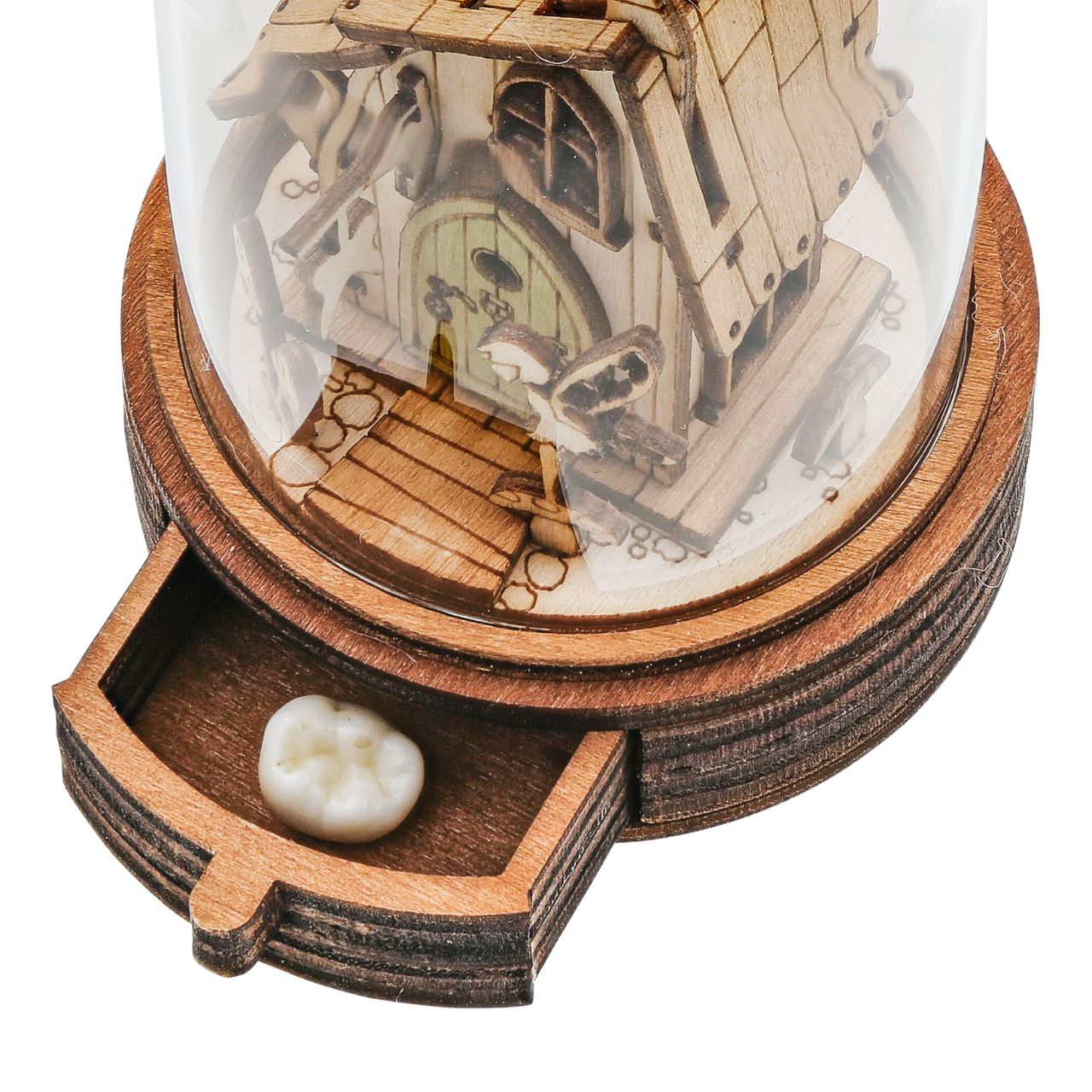 Everyone knows the story of the Tooth Fairy and now Kloche has a new way to bring that magic to your children. This glass dome decoration encases a detailed miniature of the Tooth Fairy themself in front of their Fairy home. What sets this apart from other pieces in the collection, is the little drawer built into the bottom, the perfect size for those lost teeth or a little treat from the Fairy.