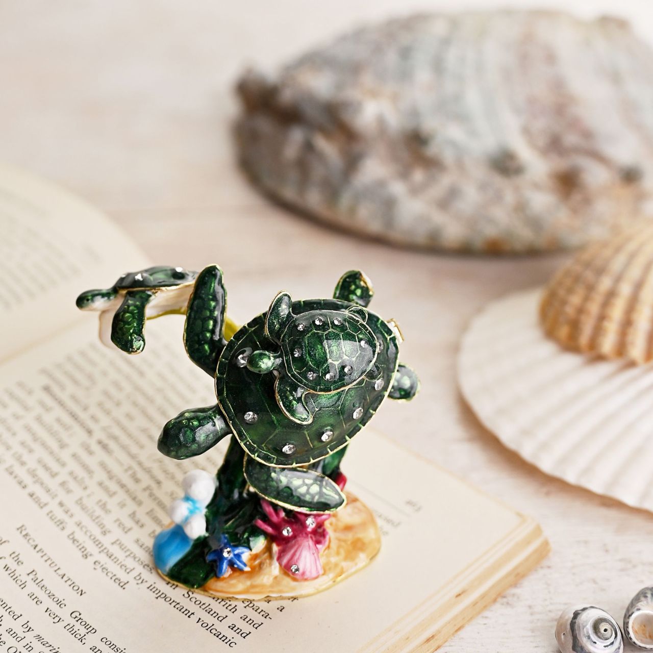 Step into the enchanting world of the Treasured Trinkets – Coral Turtle by STRATTON, a whimsical and meticulously crafted trinket box that captures the endearing charm of this sea creature.