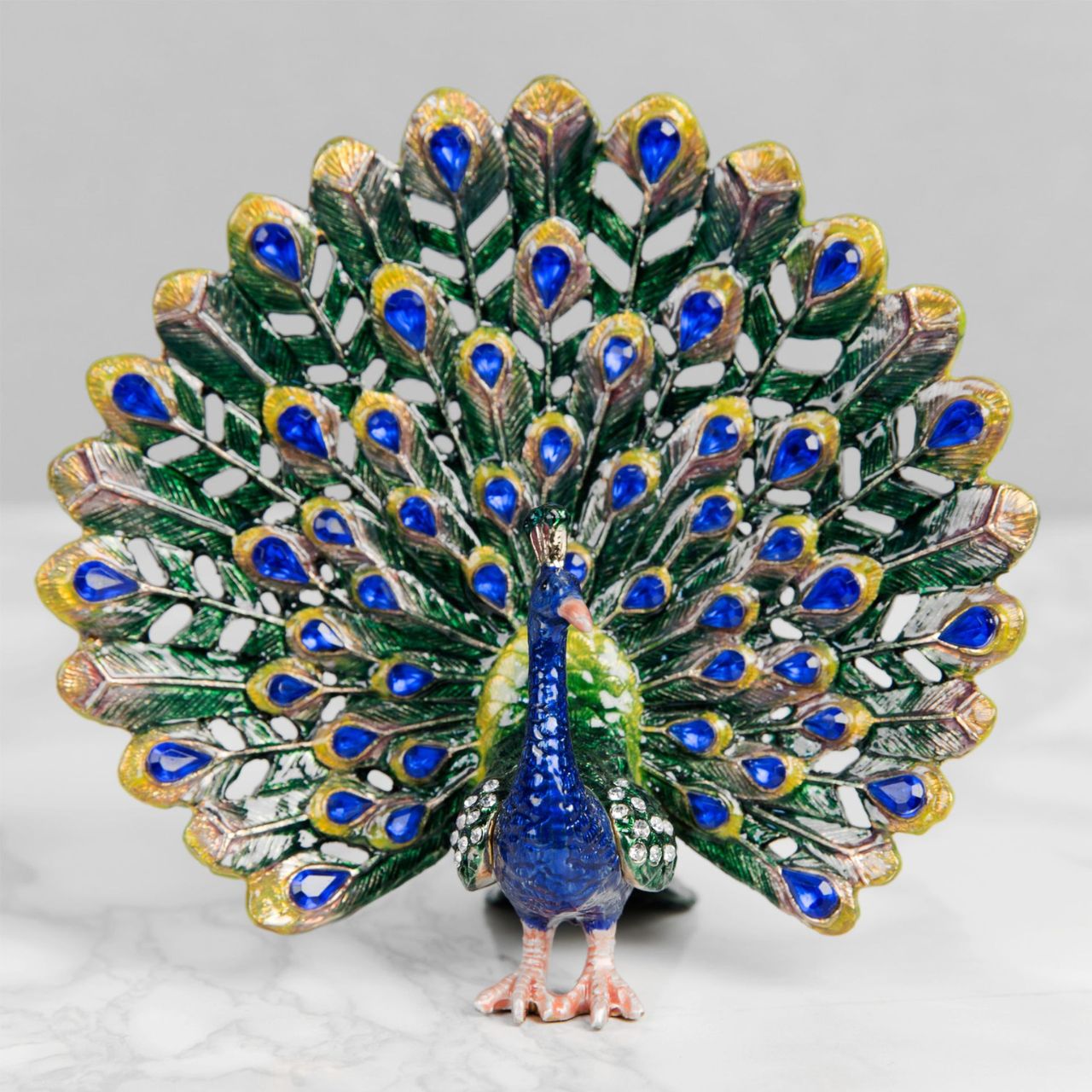 Painted in the glorious colours of a Peacock and its plumage, this peacock trinket with adorned with blue crystals that finish this wonderful ornament perfectly.