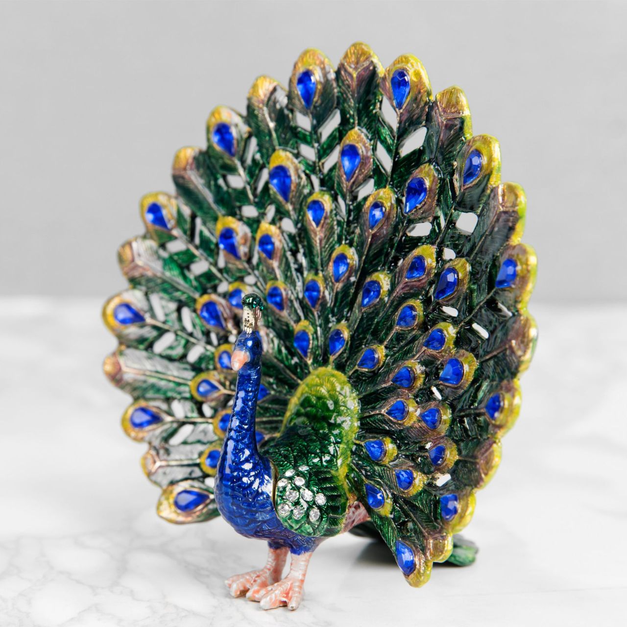 Painted in the glorious colours of a Peacock and its plumage, this peacock trinket with adorned with blue crystals that finish this wonderful ornament perfectly.