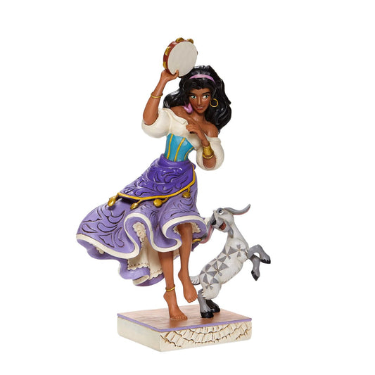 Disney Traditions Esmeralda & Djali  from The Hunchback of Notre Dame  Loyal goat Djali assists his kind-hearted gypsy owner, Esmeralda, as she performs in Disney's classic, Hunch Back of Notre Dame, in this designed by Jim Shore sculpt.