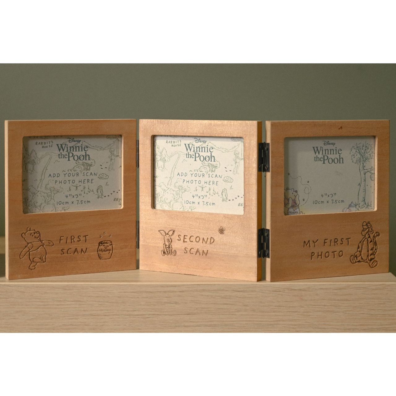 Celebrate your little one's magical milestones with this charming Disney Winnie the Pooh folding multi aperture scan frame from DISNEY.