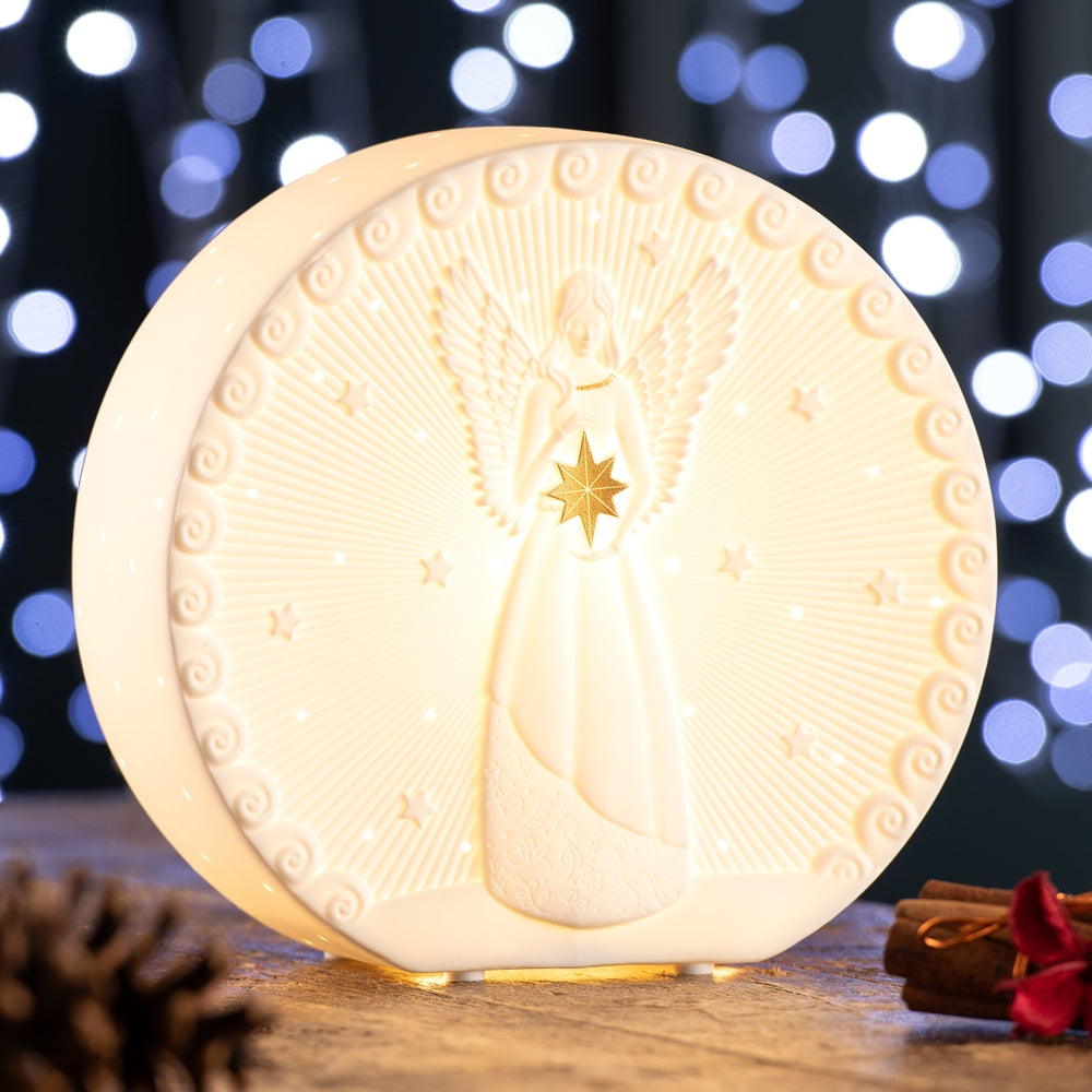 Angel Luminaire by Belleek Living Featuring an exquisitely modelled angel and stars with gold accents, this luminaire is timeless and elegant. Belleek Living Luminaire lamps emit a soft warm glow highlighting the delicate surface decoration and piercing, creating beautiful mood lighting for your home.