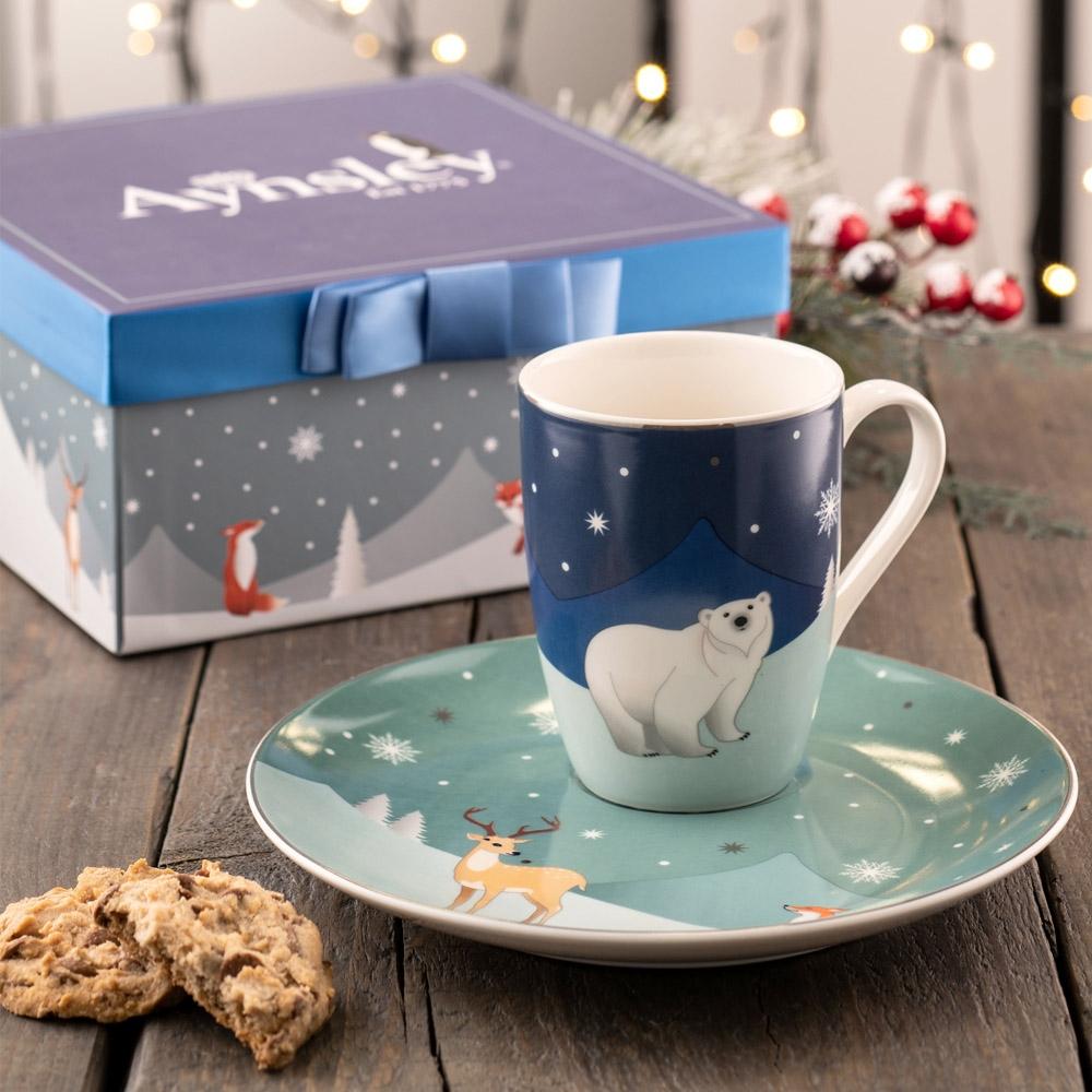 Aynsley Winter Animal Mug & Plate Set This wintery and fun set features cool blue toned snowy landscapes and cute animal illustrations. The plate features a well for the mug and is perfect for cosy nights in. This set comes beautifully boxed in a handmade gift box with ribbon.