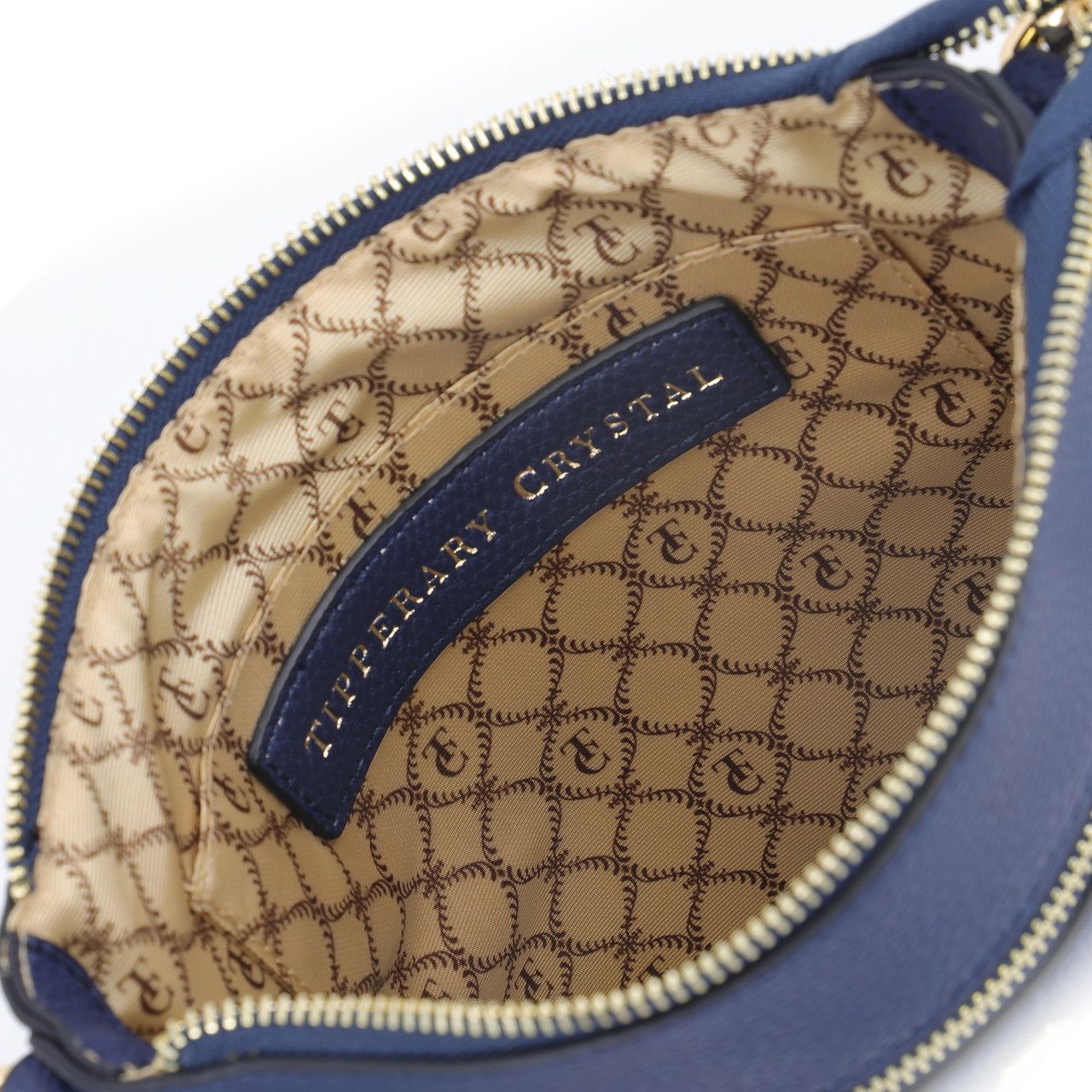 Tipperary Crystal Chelsea Cross Body Pouch - Navy New 2022 The Chelsea Cross Body Pouch Navy - Rose gold hardware The versatile and trendy Chelsea can be worn as a cross body and also over the shoulder. The Chelsea has an adjustable strap and easily accessible outside pocket and secure front zip pocket. Metal hardware detail finish off this stylish bag in rose gold or yellow gold.
