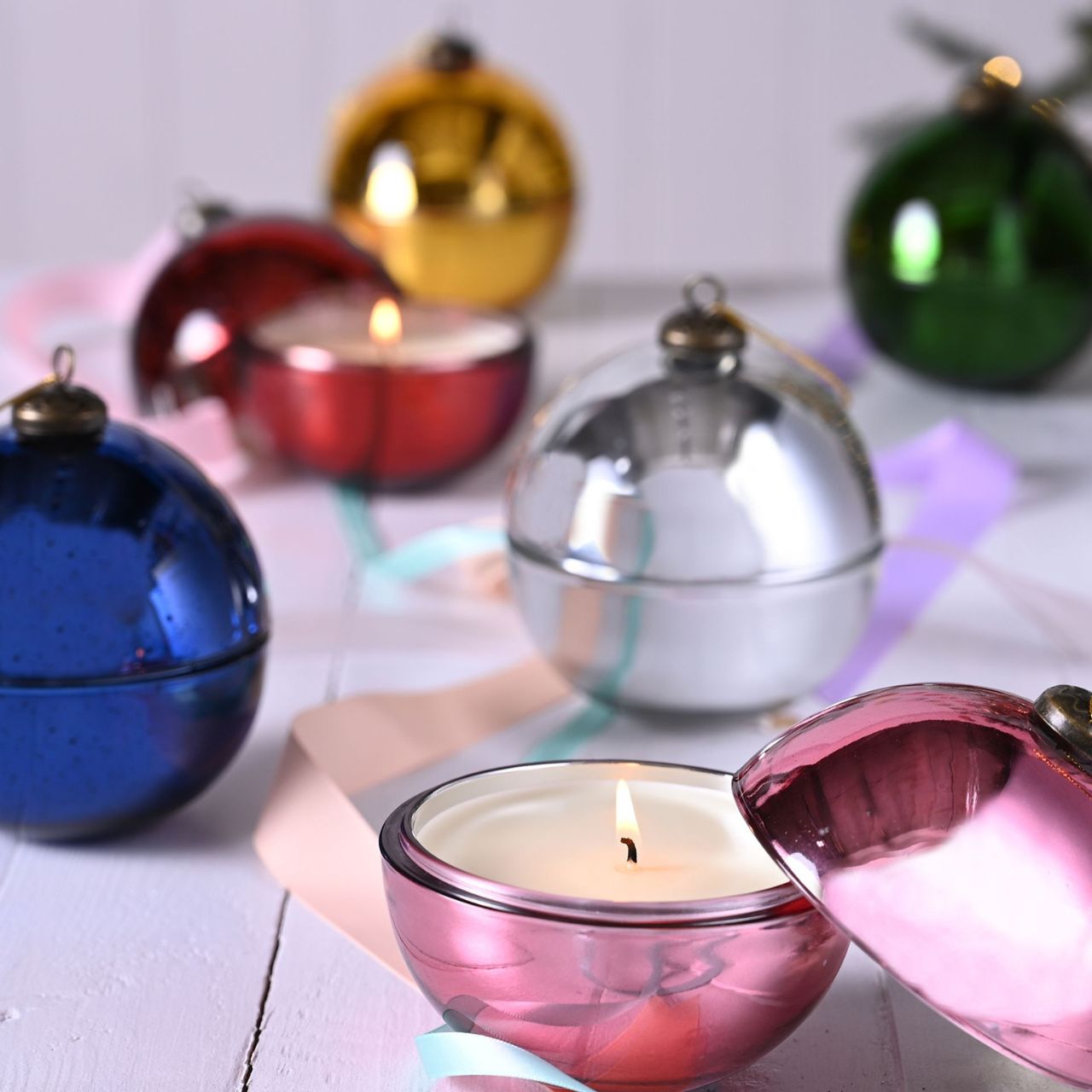 Green Holly & Fir Tree Fragranced Glass Bauble Candle A Holly & Fir Tree fragranced glass bauble candle. This aromatic candle makes an eye-catching addition to homes during the festive season.