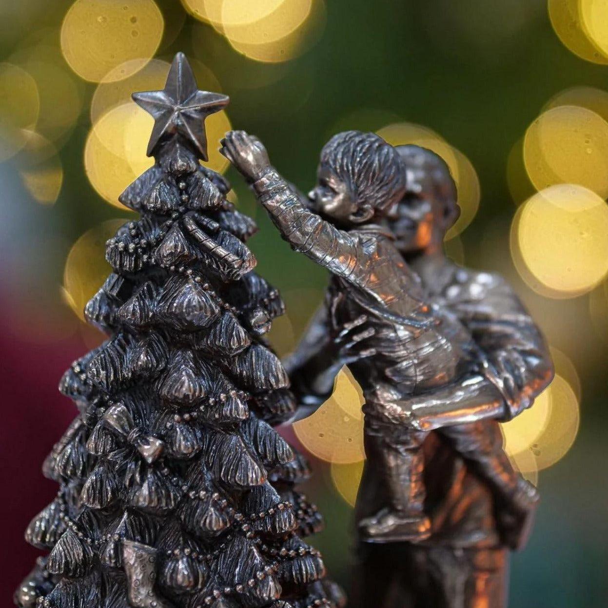 Genesis Ireland Christmas Star A stunning ornament that is sure to bring festive cheer to your home. The Christmas bronze ornament is exquisitely detailed of a father helping his young son to put the star on top of the Christmas tree, and would be an amazing gift for friends or family.