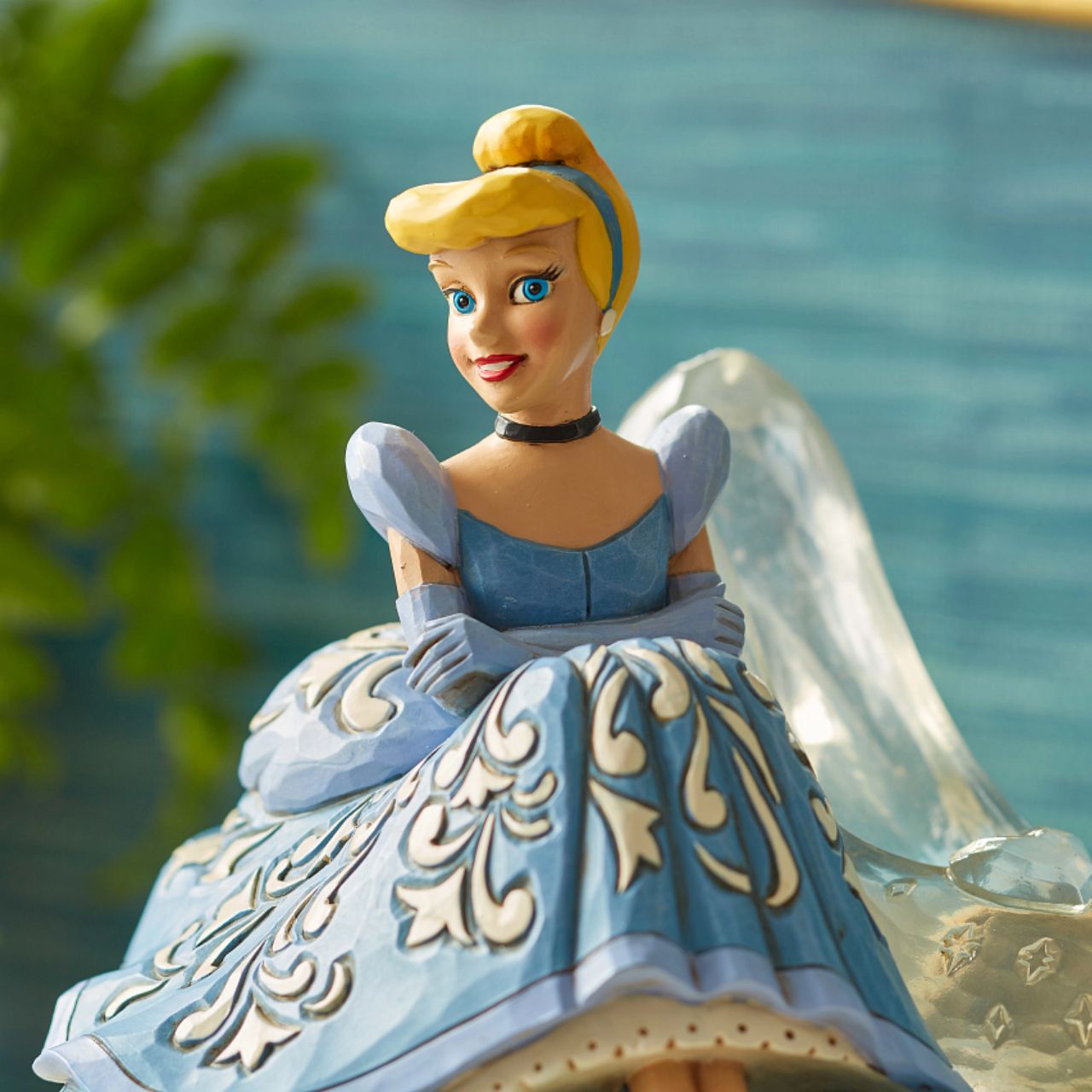 Jim Shore Disney Cinderella Glass Slipper Figurine This Disney Traditions line by Jim Shore features iconic Walt Disney princesses with their famous props highlighted. With a base illustrating her story, this piece features Cinderella in her brilliant blue gown with a glass slipper.