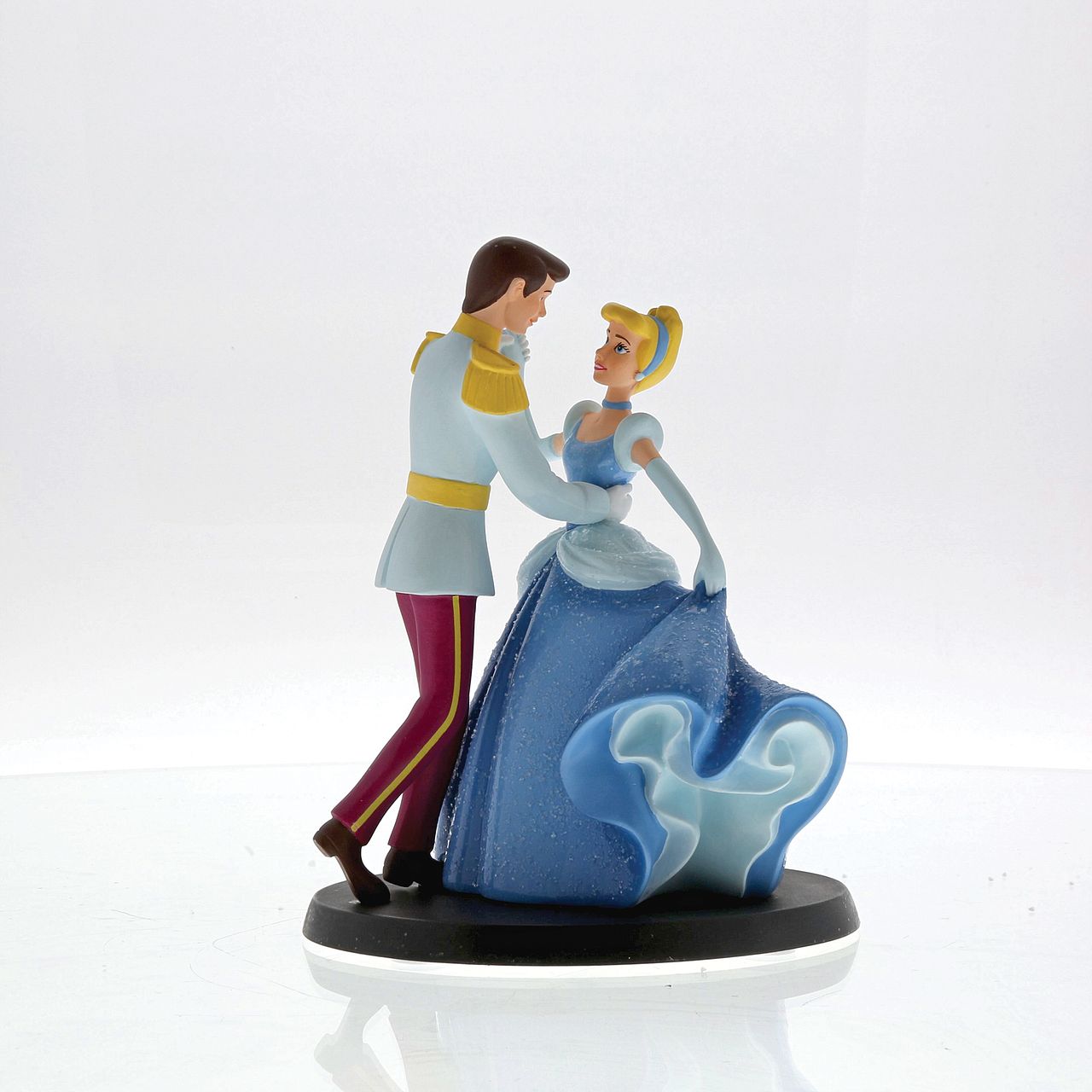 Disney Cinderella Wedding Cake Topper Place this enchanted Cinderella and Prince Charming figurine on top of your wedding cake using the plastic dish provided for a perfect representation of your happy ever after. The figurine is made from cast stone.