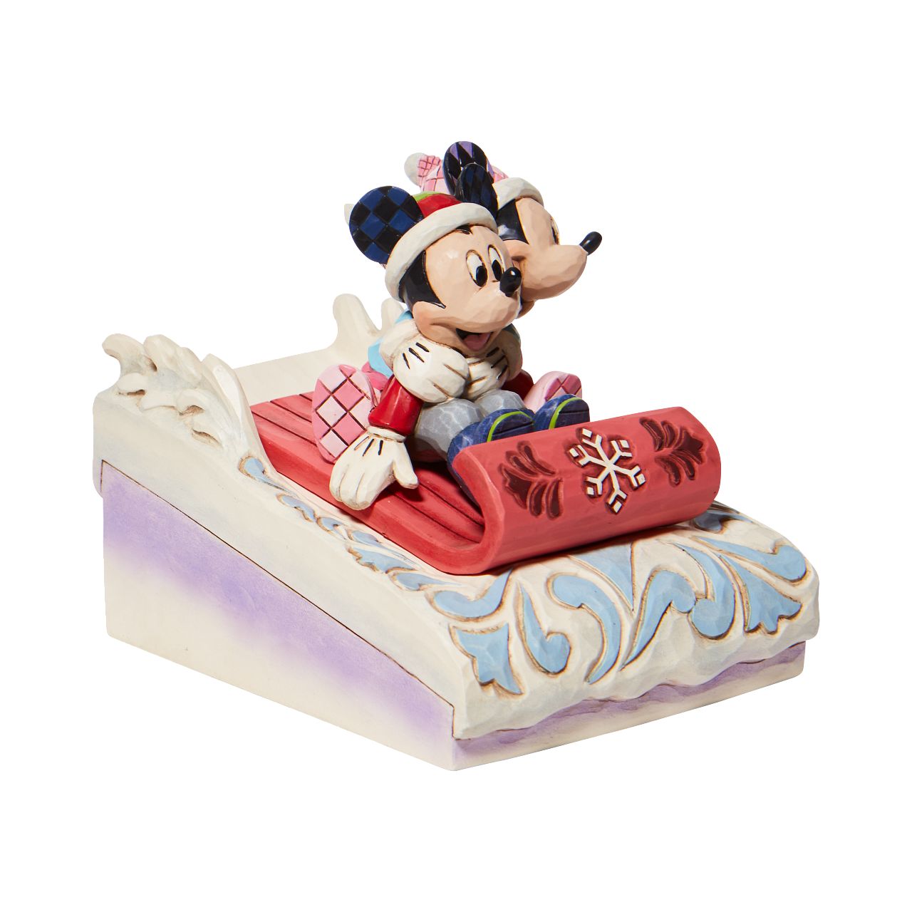Jim Shore Disney Mickey & Minnie Sledding Figurine - Sledding Sweethearts Couples that sleigh together, stay together. Disney's original duo embrace for a sled ride down Christmas Mountain. Holding her guy tight, Minnie clings onto Mickey as they go sliding in the snow. With folksy Jim Shore details they're a jolly pair. Hand painted and hand sculpted from cast stone.