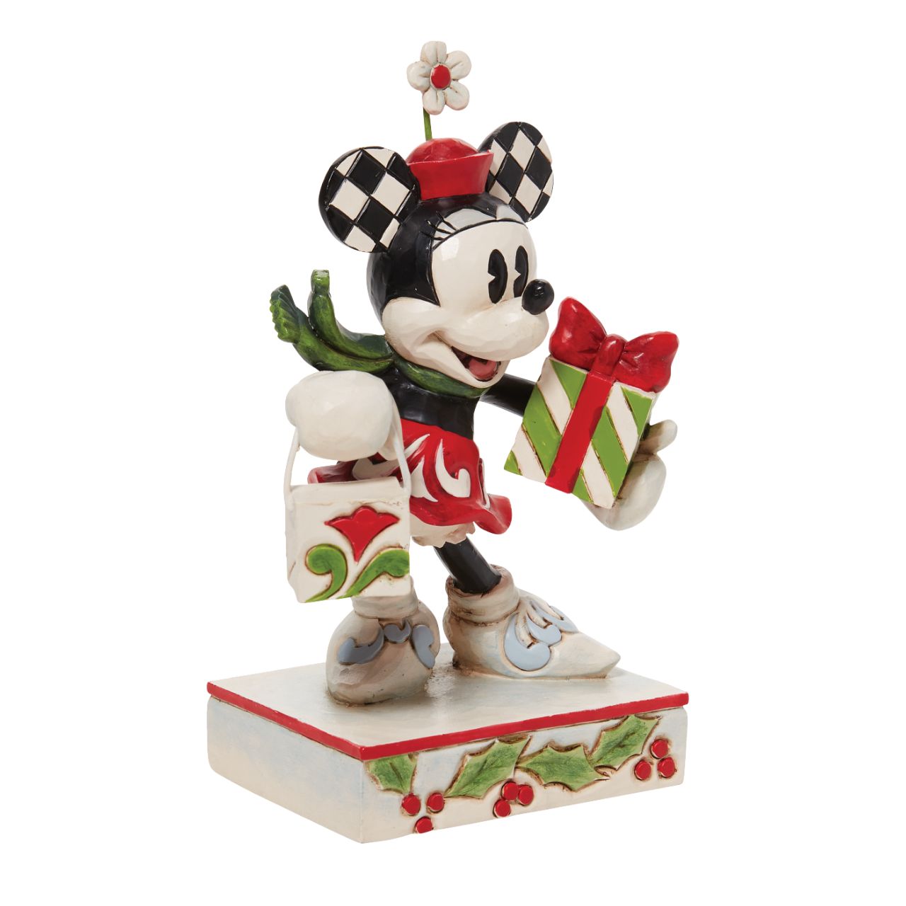 Jim Shore Christmas Minnie with Bag and Present Figurine Disney comes home for the holidays with this festive figurine by Jim Shore. Minnie Mouse is an icon of fashion and friendliness this year as she completes her Christmas shopping. Boasting with bags, she's eager to share the giving spirit with you.