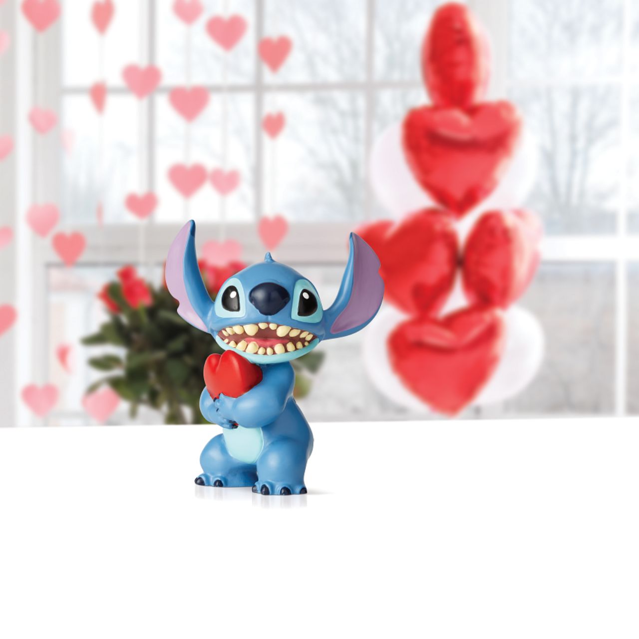 Stitch Heart Figurine Just when the creators of Experiment 626 thought he was incapable of love, Stitch learned all about how to love from his best friend Lilo. This irresistible extra-terrestrial is the perfect addition to your 'ohana.