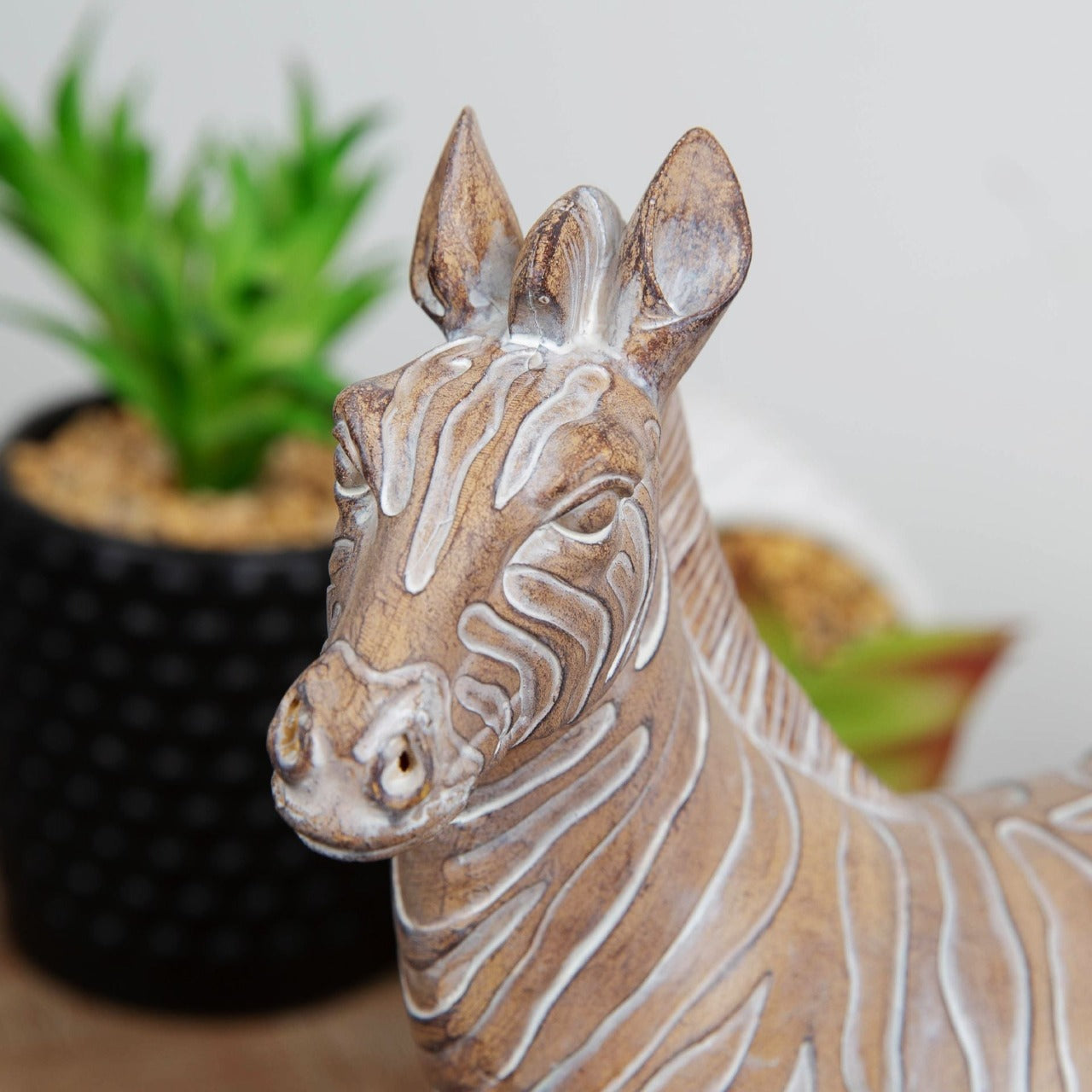Embossed Zebra Figurine 23cm Bring some exotic vibes to your home with this carved sandstone effect resin zebra ornament. From the Global Artisan collection by HESTIA® - bring a touch of the exotic to your home.